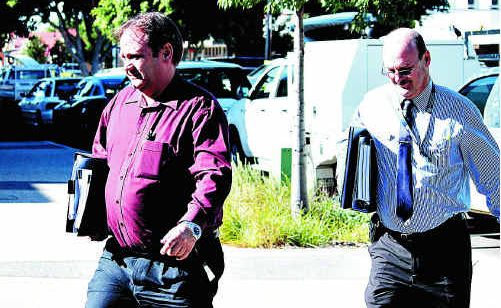 Mayor Peter Maguire and council staffer Glenn Bell arrive at the flood inquiry yesterday in Emerald. Mayor Peter Maguire and council staffer Glenn Bell arrive at the flood inquiry yesterday in Emerald.